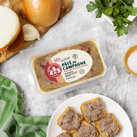 A package of savory Pate de Campagne next to a variety of fresh vegetables, perfect for a hearty dinner.