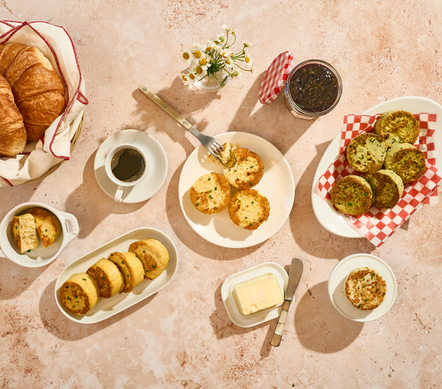 Breakfast spread with Egg Bites, coffee, and butter on a textured surface