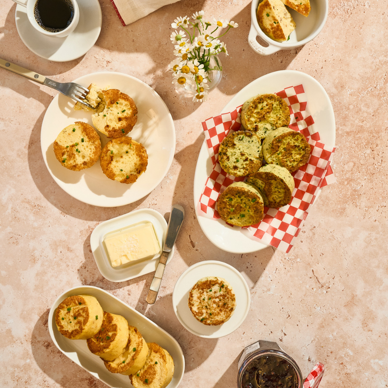 Assorted plates of Egg Bites on a table with a checkered cloth.
